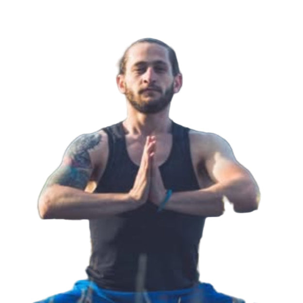 Man practicing yoga in a grassy field with trees in the background