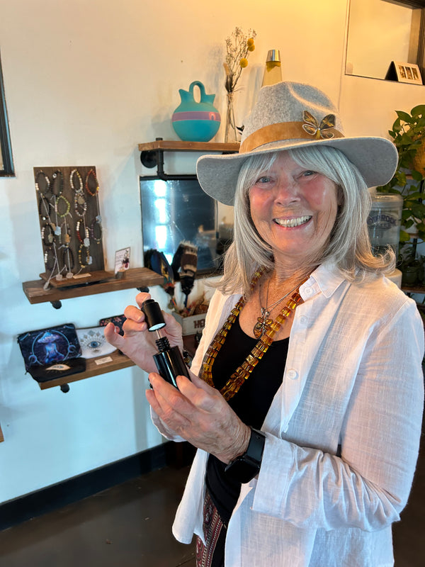 Person holding a bottle of phouse of vxn products in retail store setting