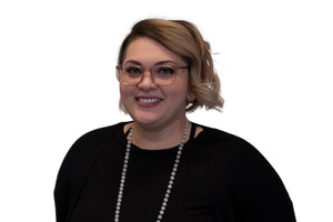 Person wearing glasses and a black top with a white background