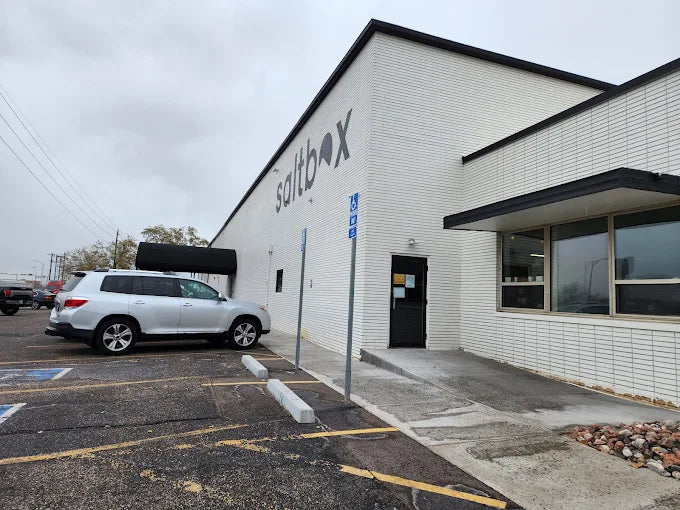 Building with 'saltbox' sign in a parking lot