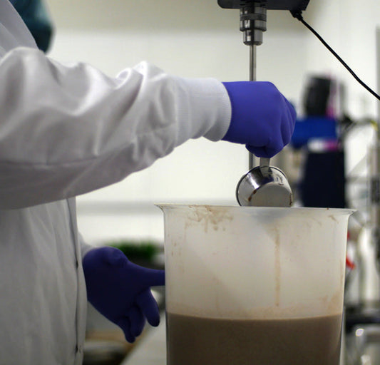 A team member mixing a scrub in Color Up's former in-house lab.