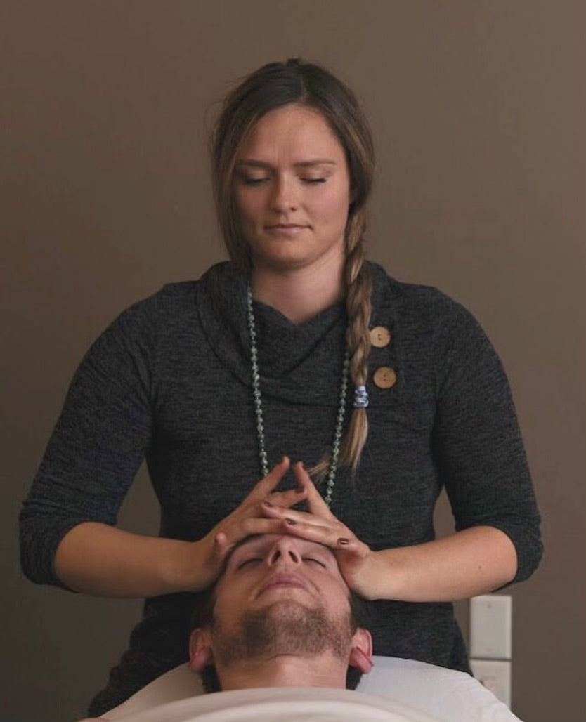 Color Up esthetician with hands on clients face during facial