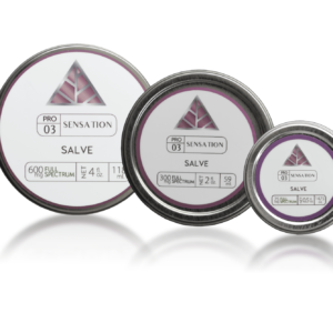 Three different sized tins with 'Color Up Salve' and pink triangle logo labels with white background