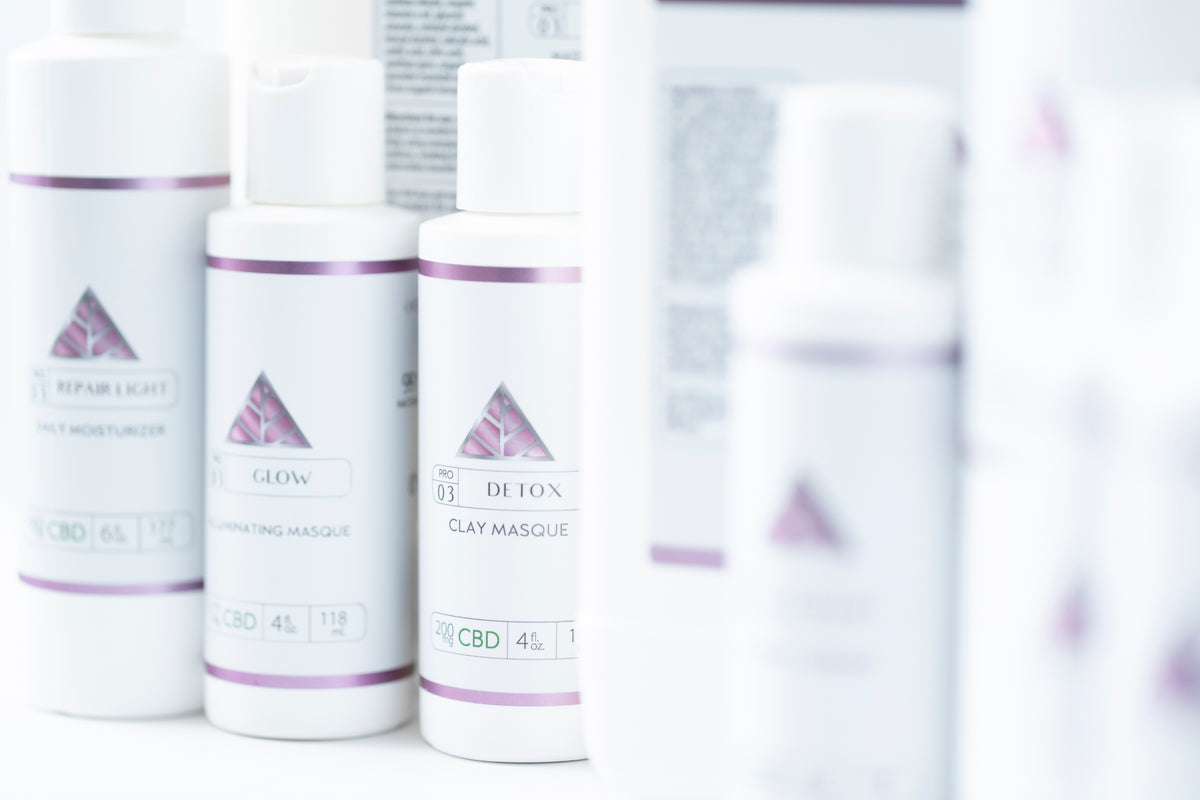 Color Up backbar sized products upclose with white labels and pink triangle logo.