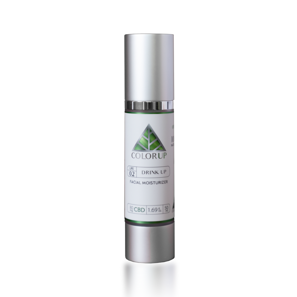 Skincare bottle labeled 'Color Up Drink Up Facial Moisturizer on a silver cosmetic bottle. 