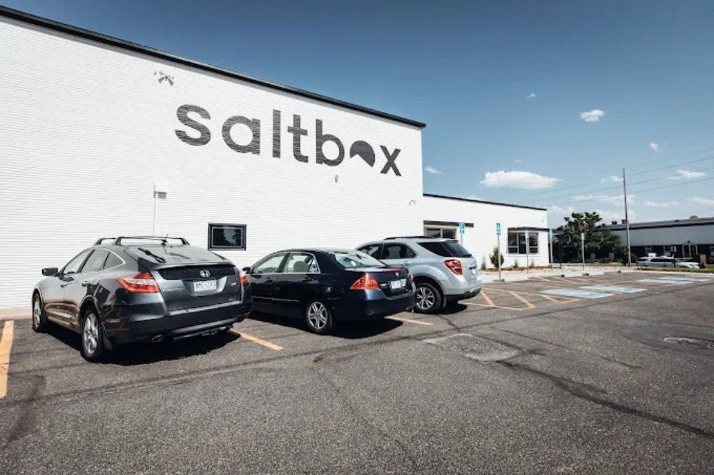 Cars parked in front of a building with 'saltbox' branding.
