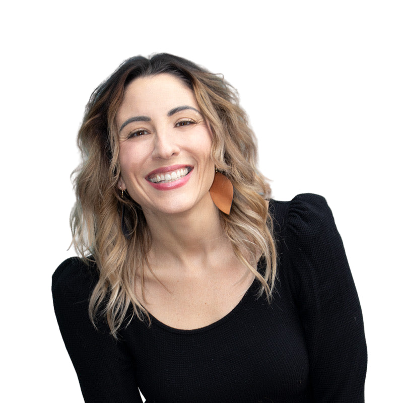 shauna, co-founder and co-owner of color up at house of vxn smiling with a turquoise concrete wall in the background