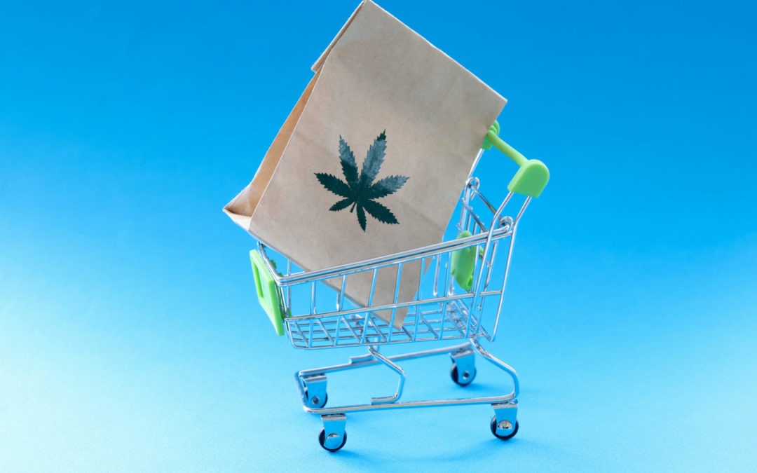 Paper bag with marijuana herb lying in metal shopping basket encouraging people to buy CBD products online