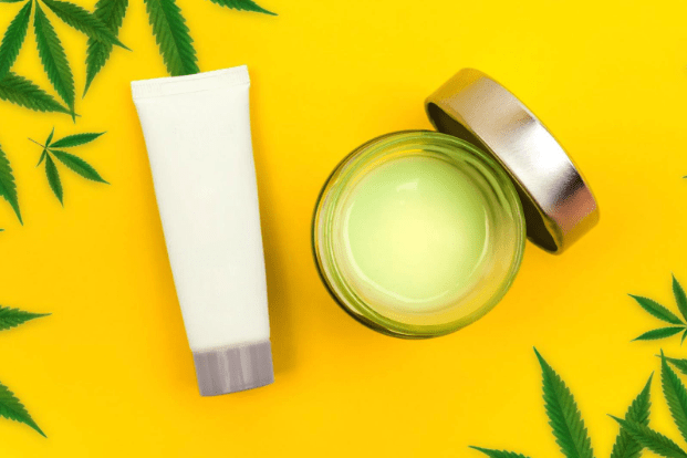 yellow background with CBD products and hemp leaves